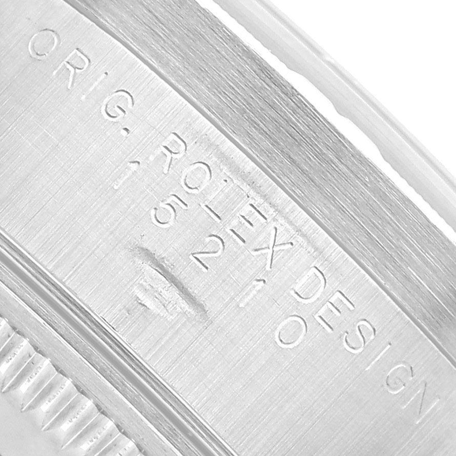 The image shows a close-up of the side of a Rolex Date 15210 Men's Stainless Steel White Dial model, highlighting the engraved serial number.