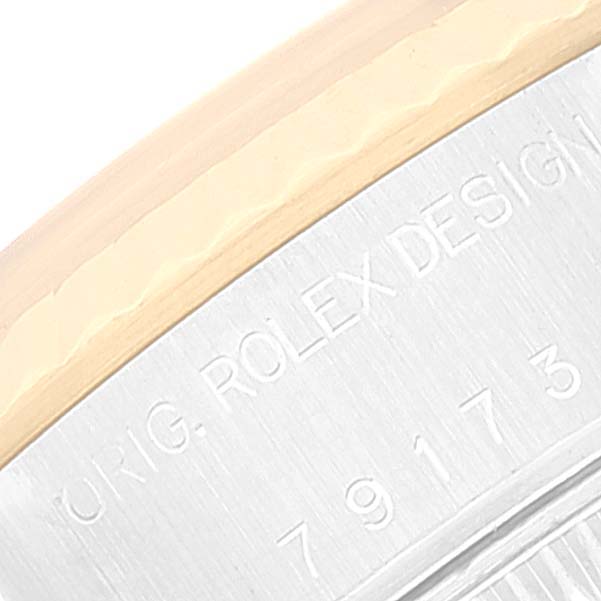 This image shows a close-up of the side of a Rolex Datejust 79173 Women's Stainless Steel Champagne Dial watch, focusing on the bezel and engraved details.