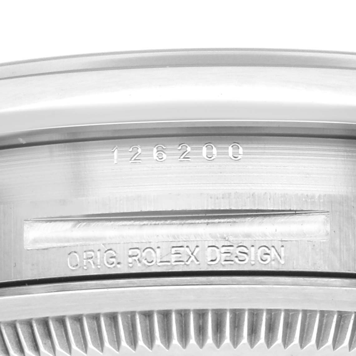 This close-up shows the case side of a Rolex Datejust 126200 Men
s Stainless Steel Black Dial 126200 Men
s Stainless Steel Black Dial, highlighting the model number and design engraving.