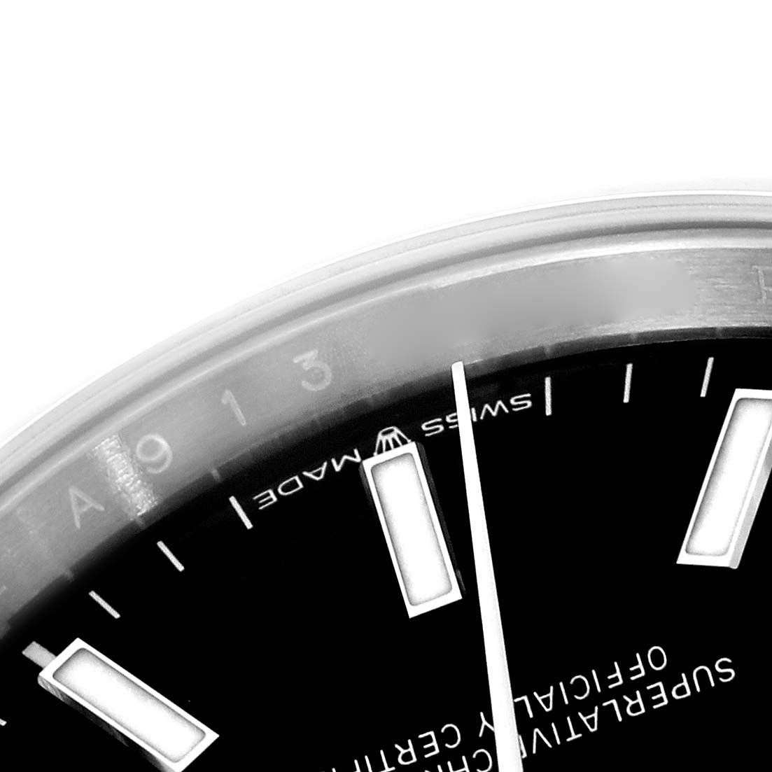 The image shows a close-up of the dial of a Rolex Datejust 126200 Men
s Stainless Steel Black Dial 126200 Men
s Stainless Steel Black Dial, focusing on the hour markers and text.