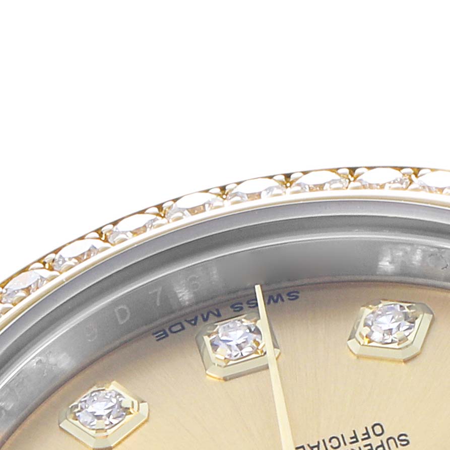 The image shows a close-up of a Rolex Datejust 179383 Women's Steel and Gold (two tone) Champagne Dial watch, featuring its diamond bezel and part of the dial with diamond hour markers.