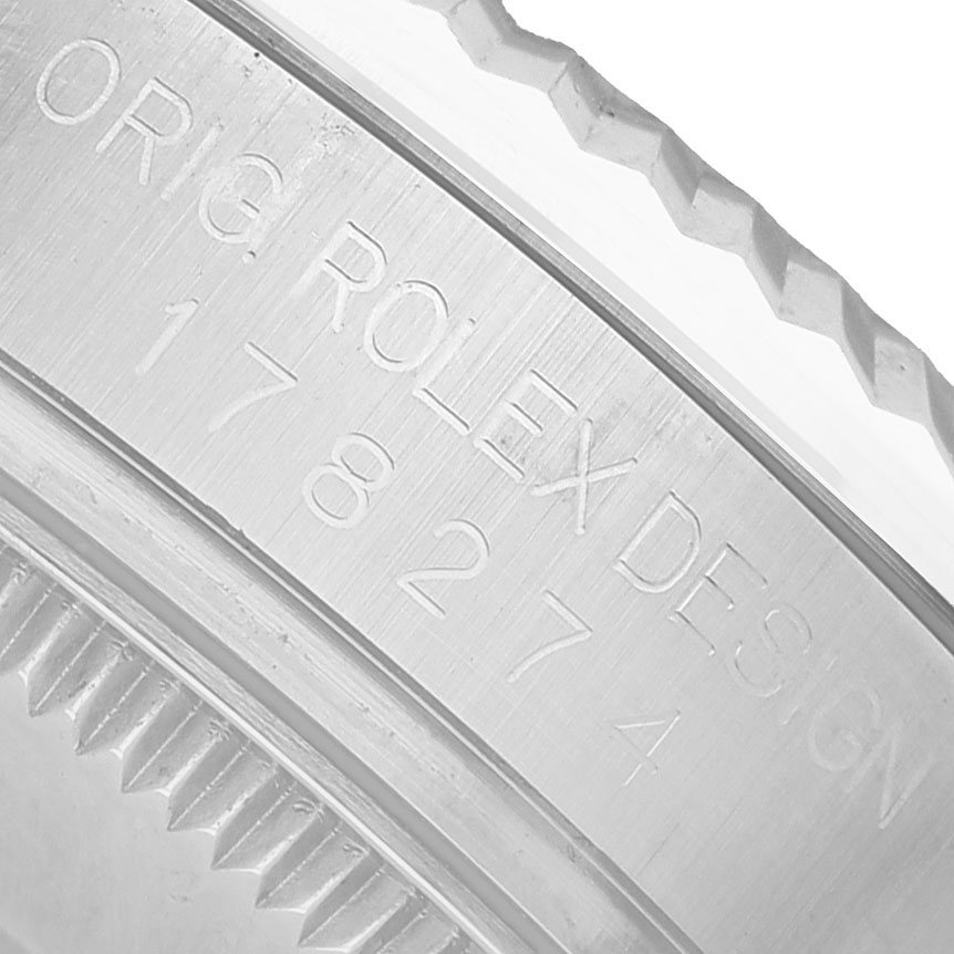 The image shows an engraved side of a Rolex Datejust 178274 Women's Steel and Gold (two tone) Black Dial watch case with the serial number and design details.