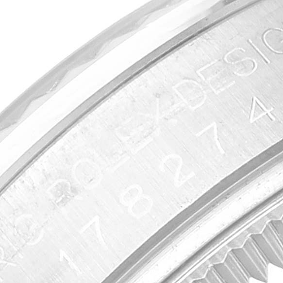This image shows a close-up of the polished and engraved bezel of a Rolex Mid-Size 178274 Women's Stainless Steel Black Dial 178274 Women's Stainless Steel Black Dial watch.