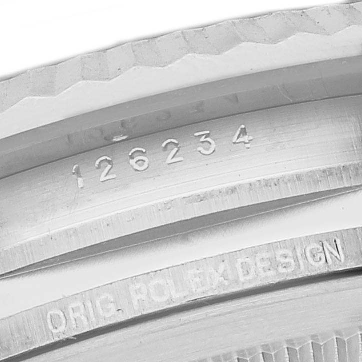 This close-up image of a Rolex Datejust 126234 Men
s Stainless Steel Blue Dial 126234 Men
s Stainless Steel Blue Dial watch shows the model number "126234" and "ORIG ROLEX DESIGN" engraved on the case edge.