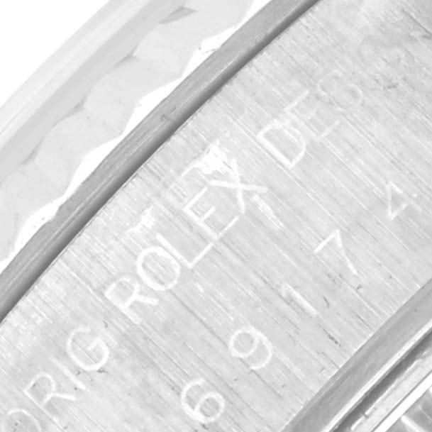 The image shows a close-up of the inner engraving on the Rolex Datejust 69174 Women's Stainless Steel Blue Dial 69174 Women's Stainless Steel Blue Dial bezel.