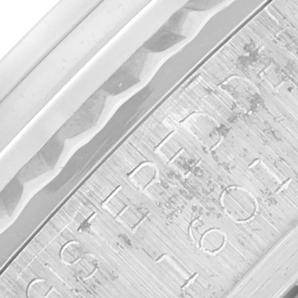 The image shows a close-up of the engraved edge on the Vintage Collection model by Rolex.