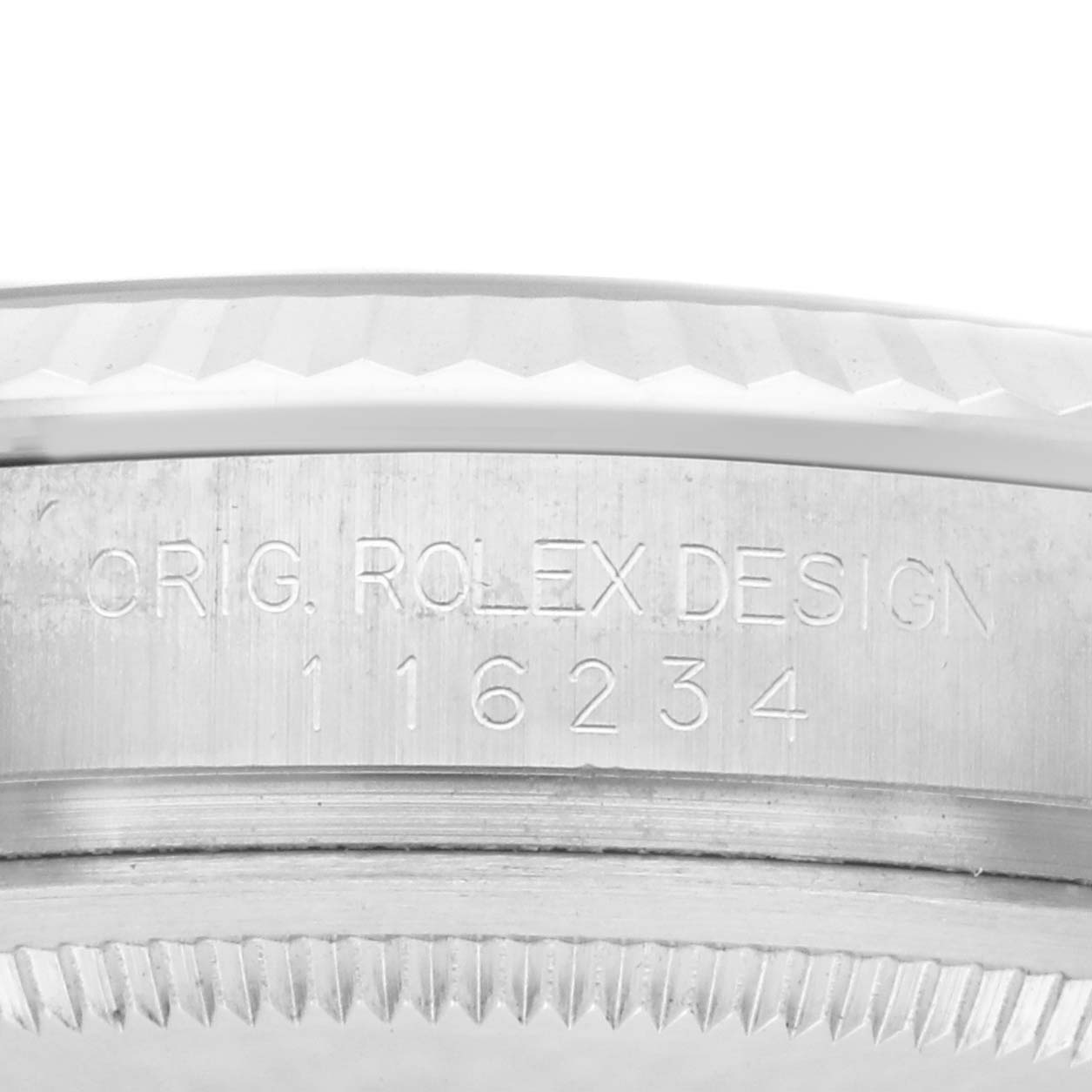 The image shows a close-up of a Rolex Datejust 116234 Men
s Stainless Steel Black Dial 116234 Men
s Stainless Steel Black Dial model
s engraved case side with the serial number.