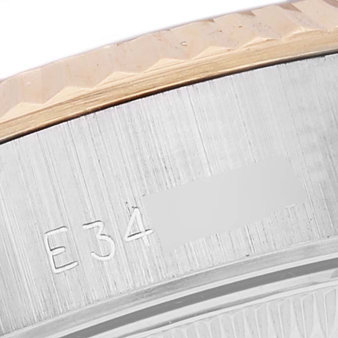 This close-up shot shows part of the bezel and case of a Rolex Datejust 69173 Women's Stainless Steel Champagne Dial 69173 Women's Stainless Steel Champagne Dial watch from an angled perspective.