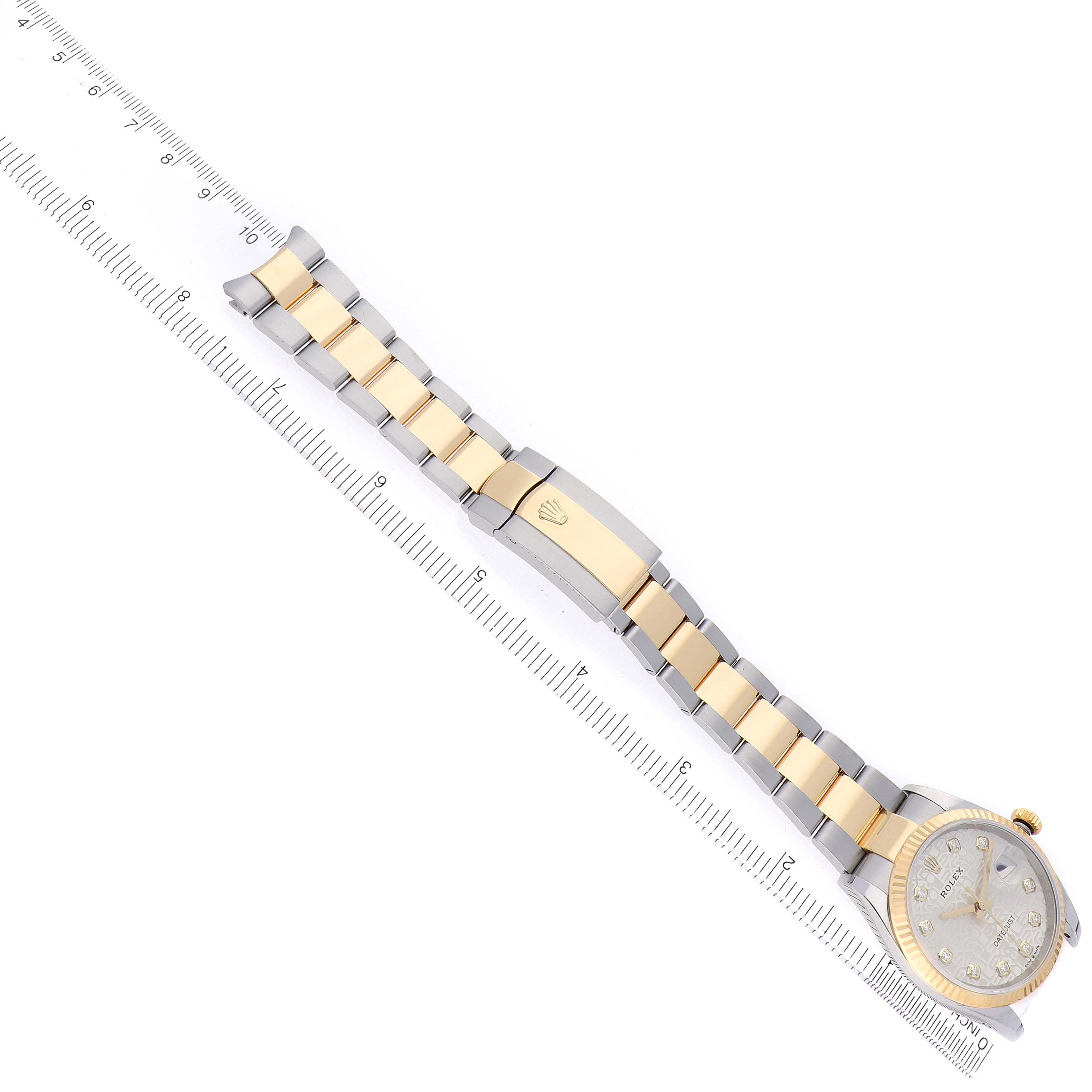 The image shows a Rolex Datejust 126233 Men's Steel and Gold (two tone) Silver Dial watch from an overhead angle, highlighting its bracelet, clasp, and partial view of the face.