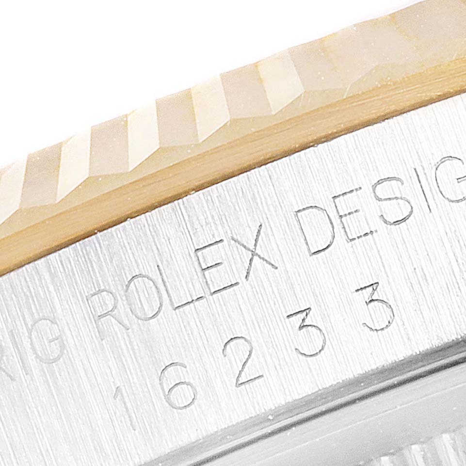 The image shows a close-up of the fluted bezel and the engraved rehaut of a Rolex Datejust 16233 Men's Steel and Gold (two tone) Champagne Dial 16233 Men's Steel and Gold (two tone) Champagne Dial watch.