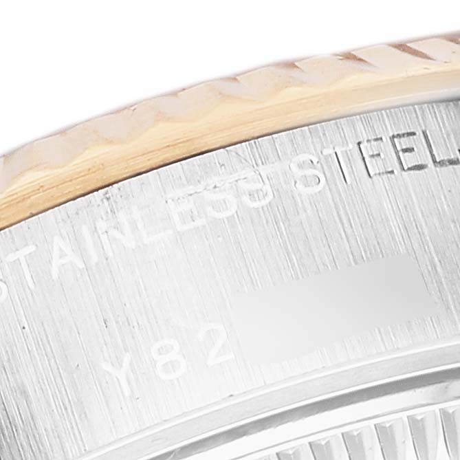 This image shows the edge and part of the engraved case back of a Rolex Datejust 79173 Women's Stainless Steel White Dial 79173 Women's Stainless Steel White Dial watch.