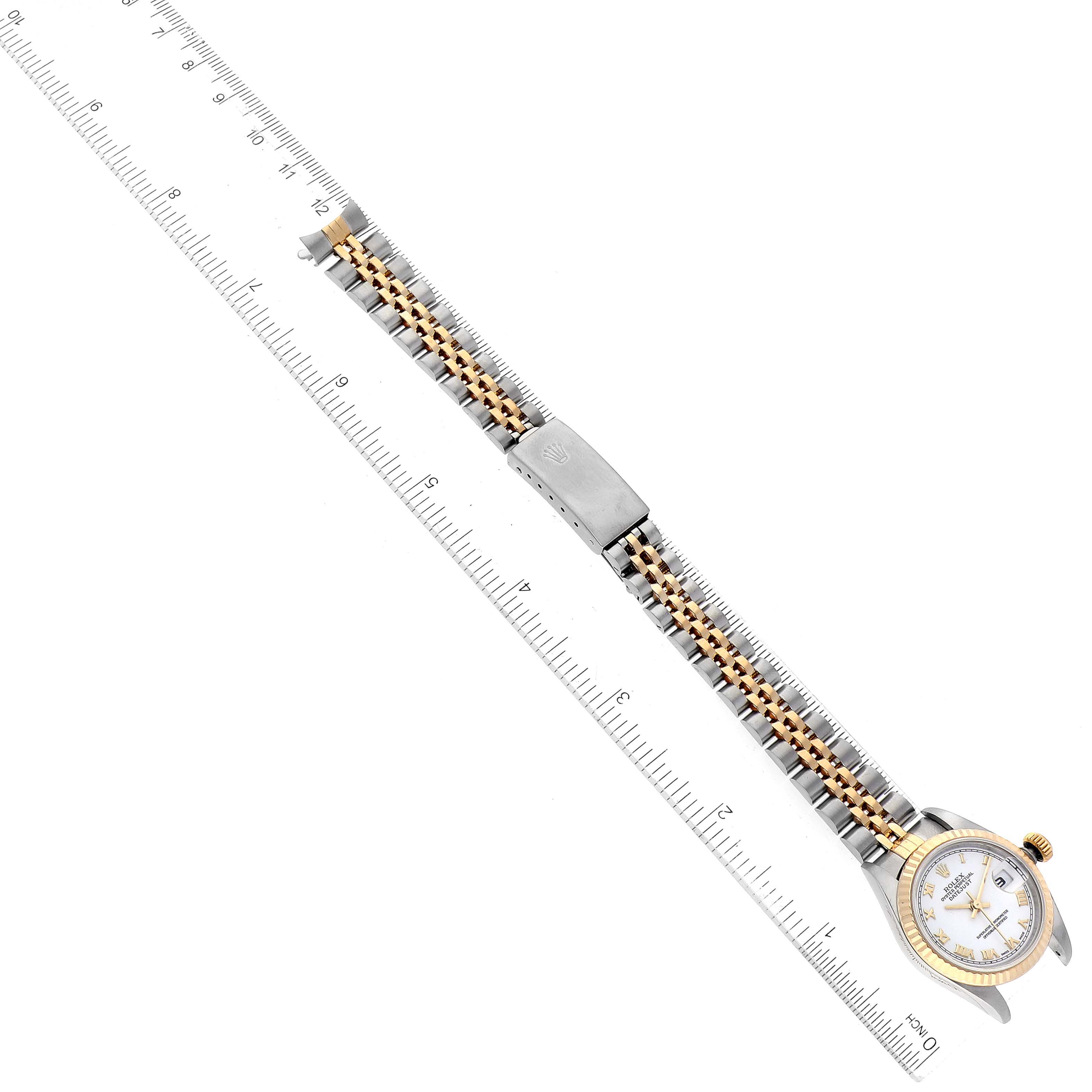 The image shows a Rolex Datejust 79173 Women's Stainless Steel White Dial 79173 Women's Stainless Steel White Dial watch laid flat alongside a ruler, highlighting the band and part of the watch face.