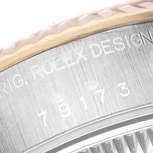 This close-up image shows the serial number and part of the bezel of a Rolex Datejust 79173 Women's Stainless Steel White Dial 79173 Women's Stainless Steel White Dial model watch.