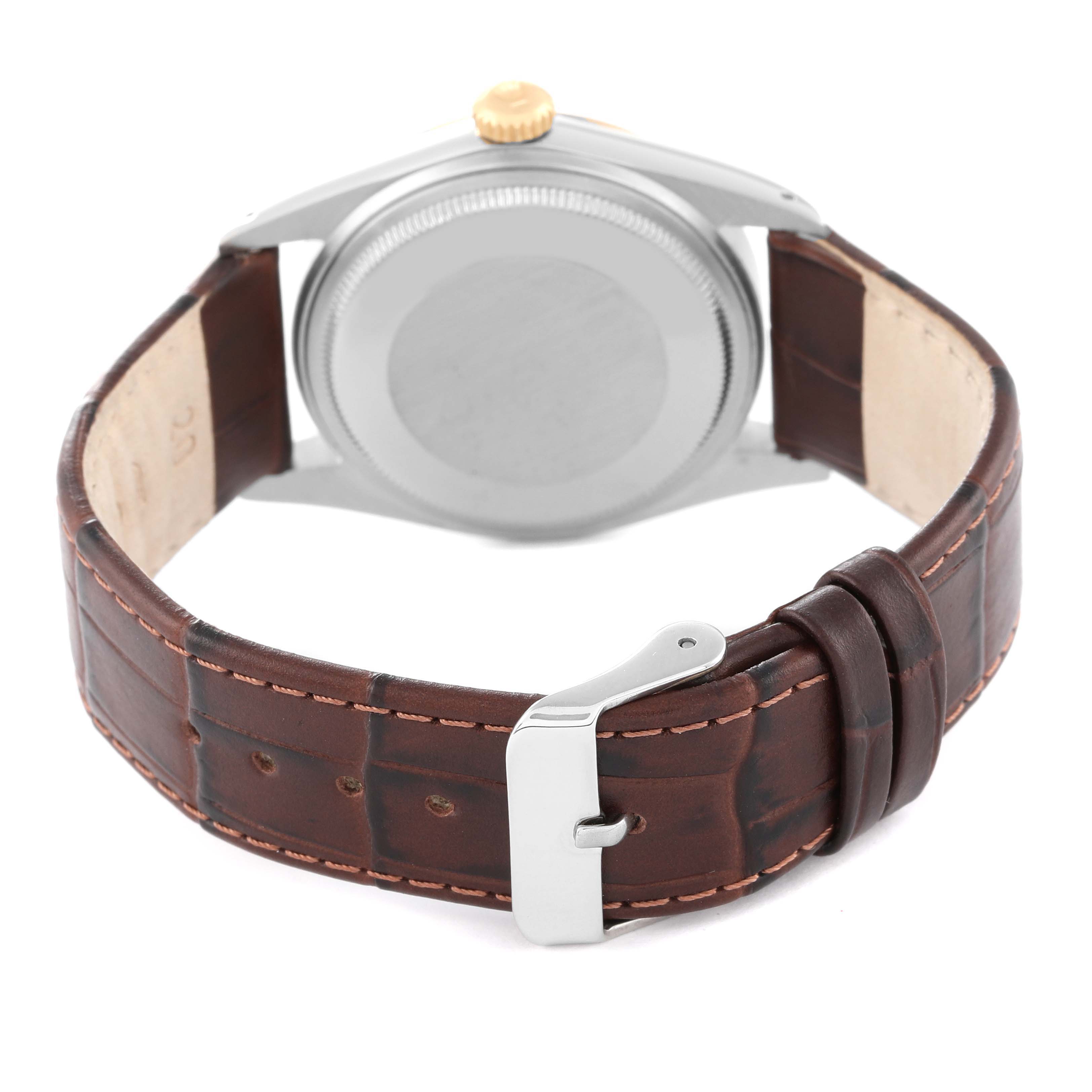 The image shows the back view of a Rolex Datejust 16013 Men's Stainless Steel White Dial 16013 Men's Stainless Steel White Dial watch, highlighting its case, crown, and leather strap with a clasp.