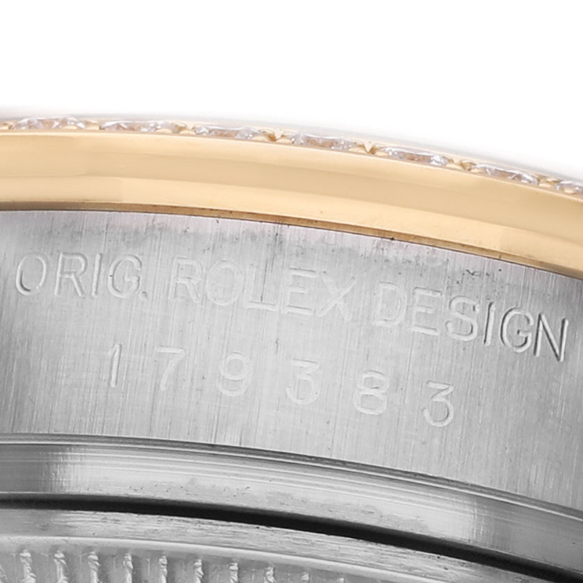 The image shows the side engraving and a glimpse of the bezel of the Rolex Datejust 179383 Women's Steel and Gold (two tone) White Dial watch.