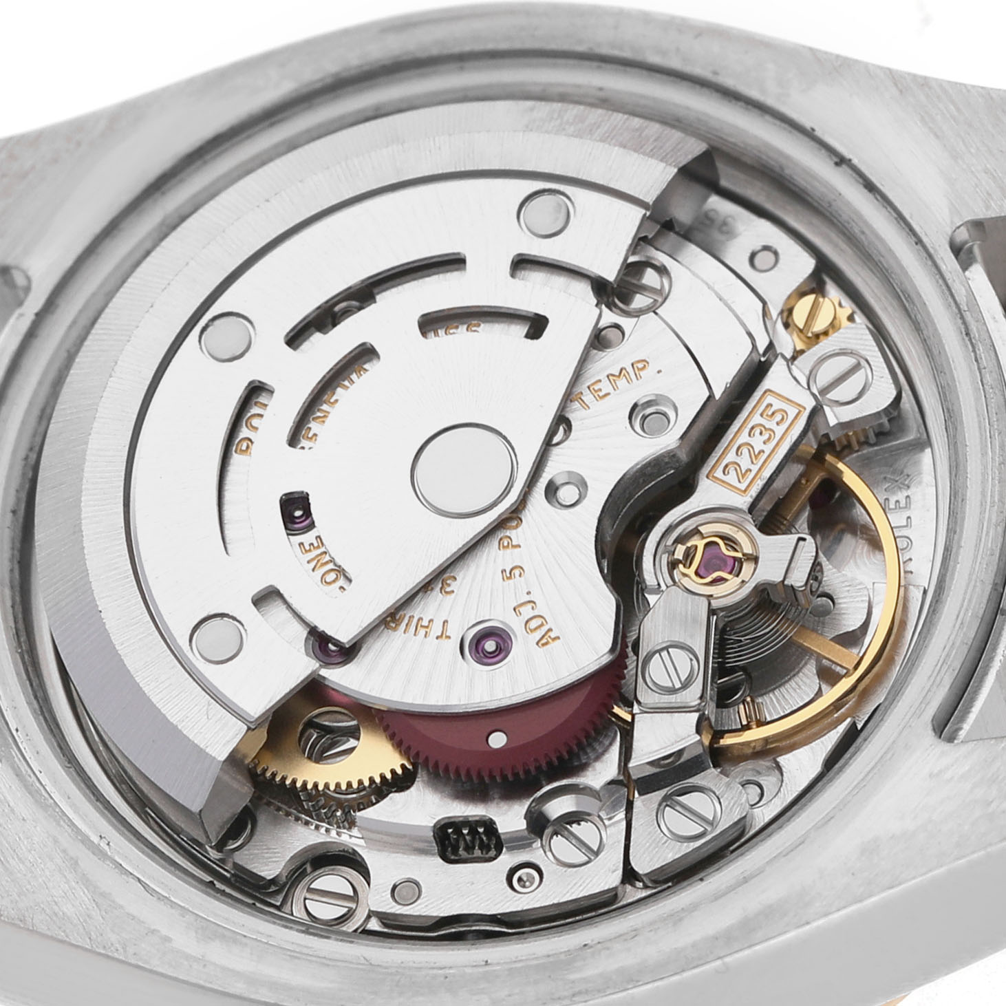 The image shows the movement of the Rolex Datejust 179383 Women's Steel and Gold (two tone) White Dial watch, featuring its intricate gears and rotor from a top-down angle.