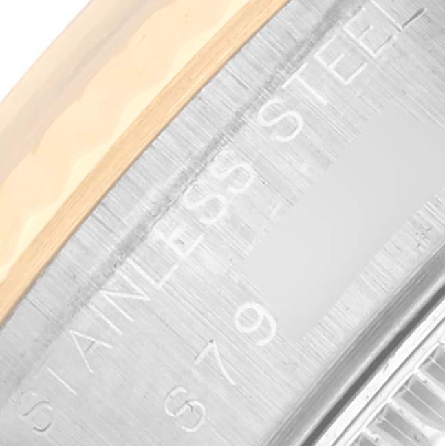 The image shows an angled close-up of the Rolex Datejust 69173 Women's Steel and Gold (two tone) White Dial 69173 Women's Steel and Gold (two tone) White Dial's case, featuring "STAINLESS STEEL" engraving.