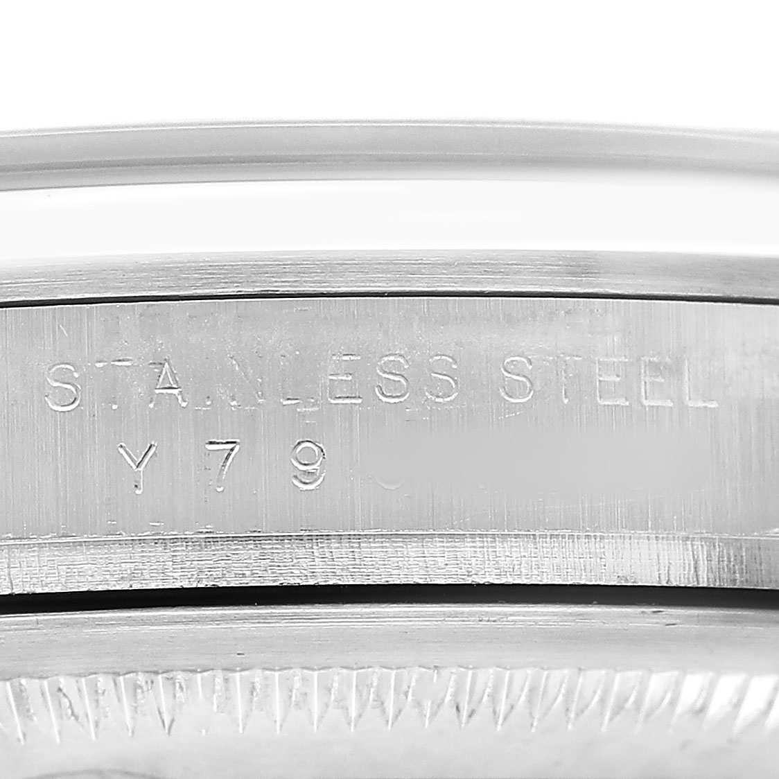 The image shows a close-up of the Rolex Explorer 114270 Men's Stainless Steel Black Dial model's stainless steel case, highlighting the engraved serial number.