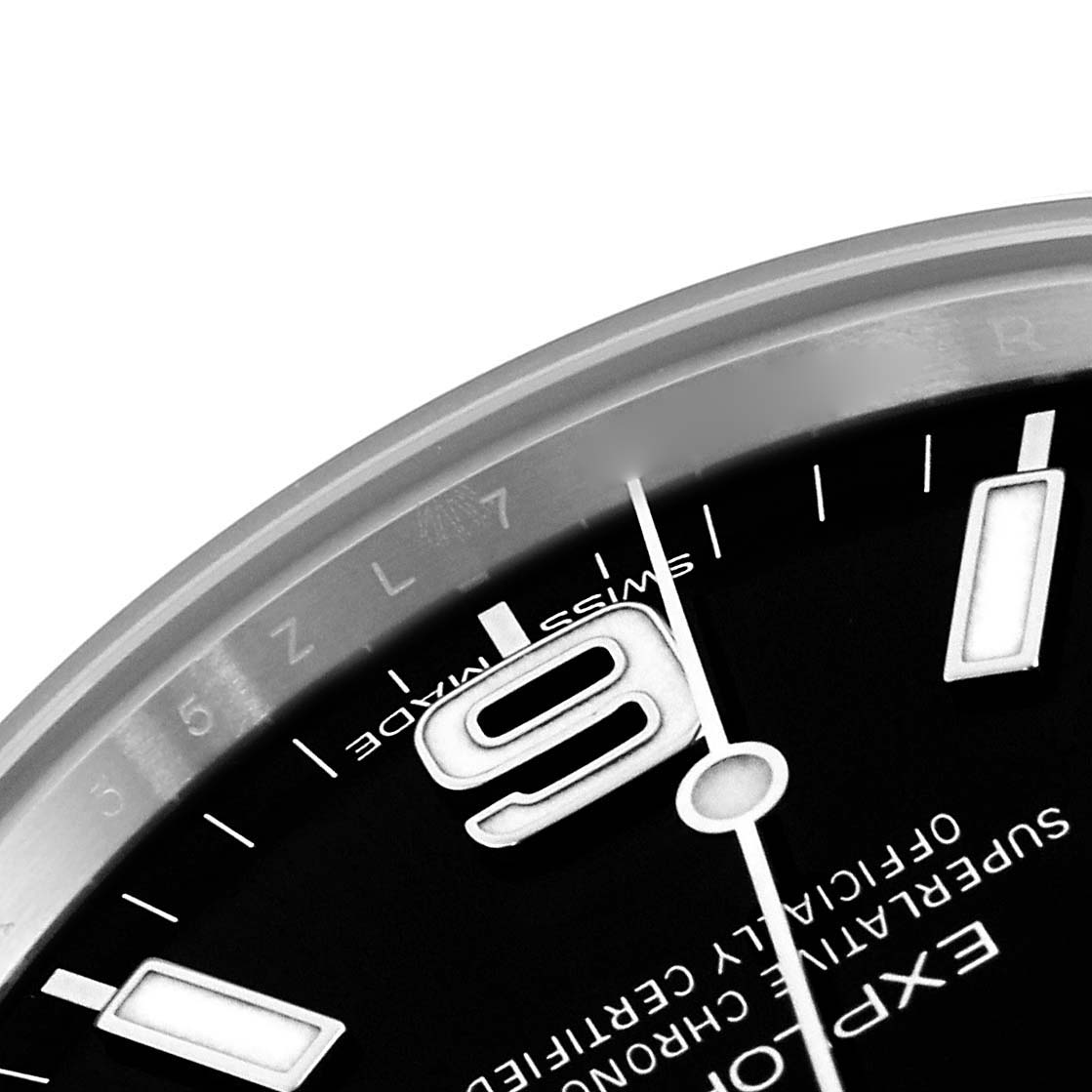 The image shows a close-up of the dial of a Rolex Explorer 214270 Men
s Stainless Steel Black Dial 214270 Men
s Stainless Steel Black Dial, focusing on the 9 o
clock position and surrounding text.