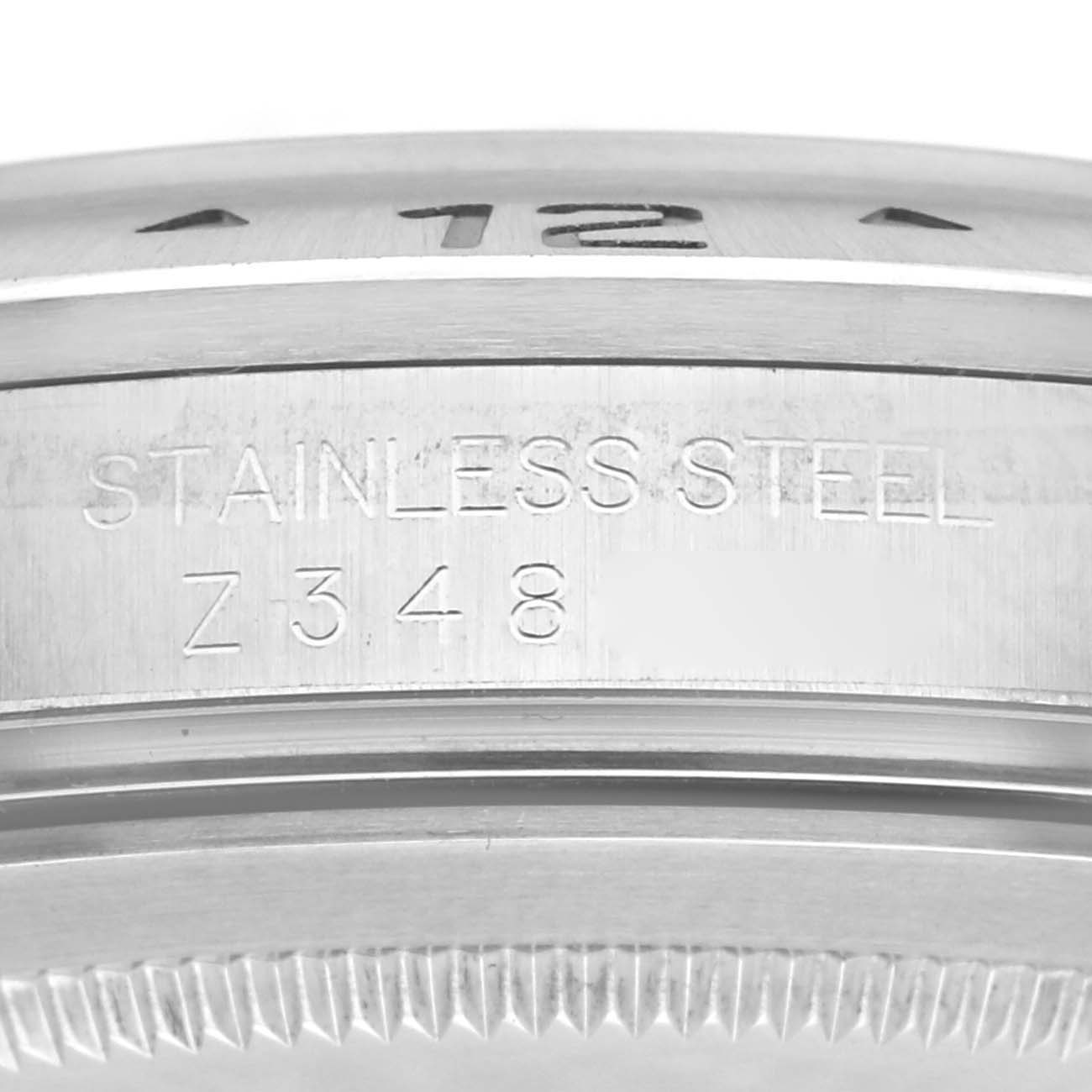 The image shows a close-up of the side of a Rolex Explorer 16570 Men's Stainless Steel Black Dial 16570 Men's Stainless Steel Black Dial watch, focusing on the bezel and the engraved markings.