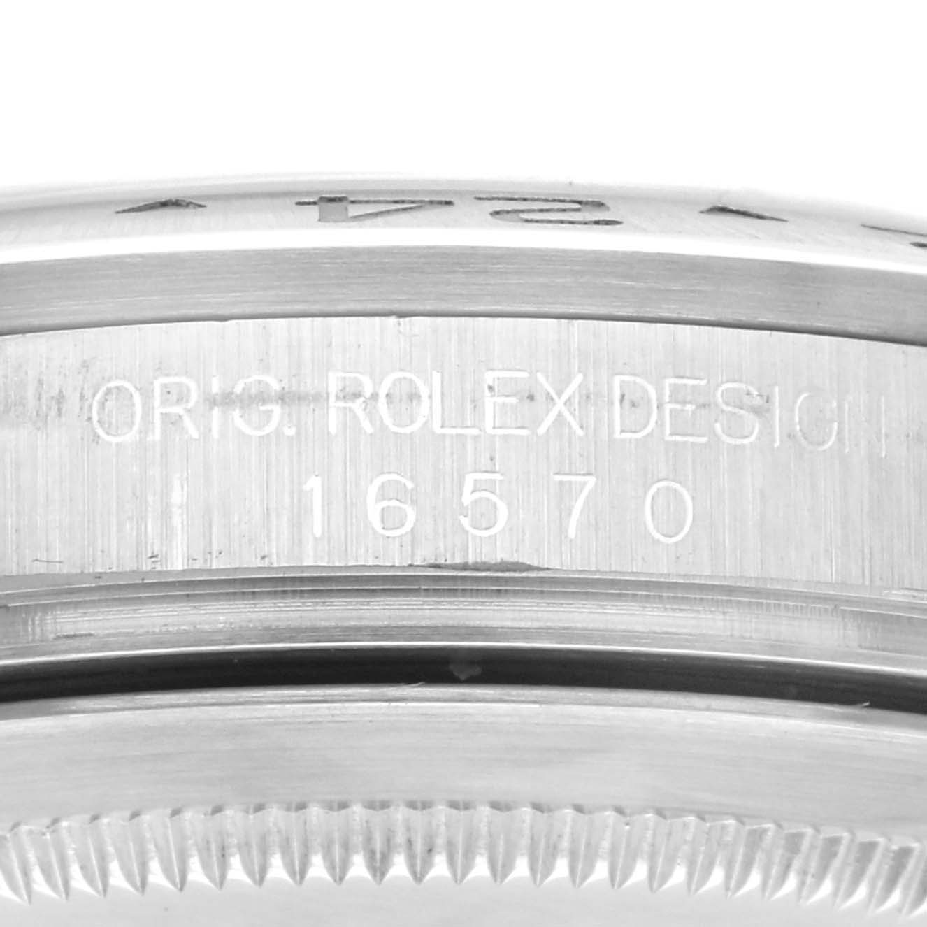 The image shows a close-up side view of a Rolex Explorer 16570 Men's Stainless Steel White Dial 16570 Men's Stainless Steel White Dial model, focusing on the engraved watch case edge.