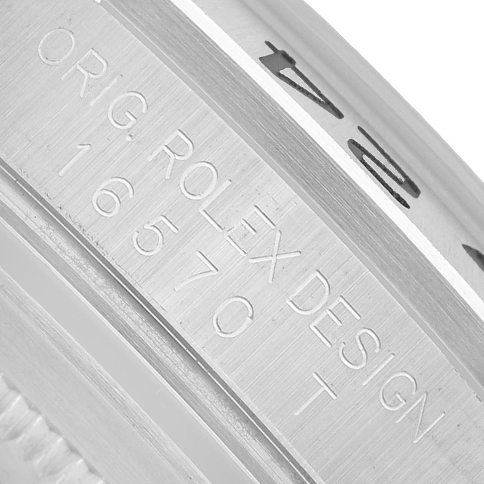 The image shows a close-up of the side of a Rolex Explorer 16570 Men's Stainless Steel White Dial watch case, highlighting the engraved model number and design details.
