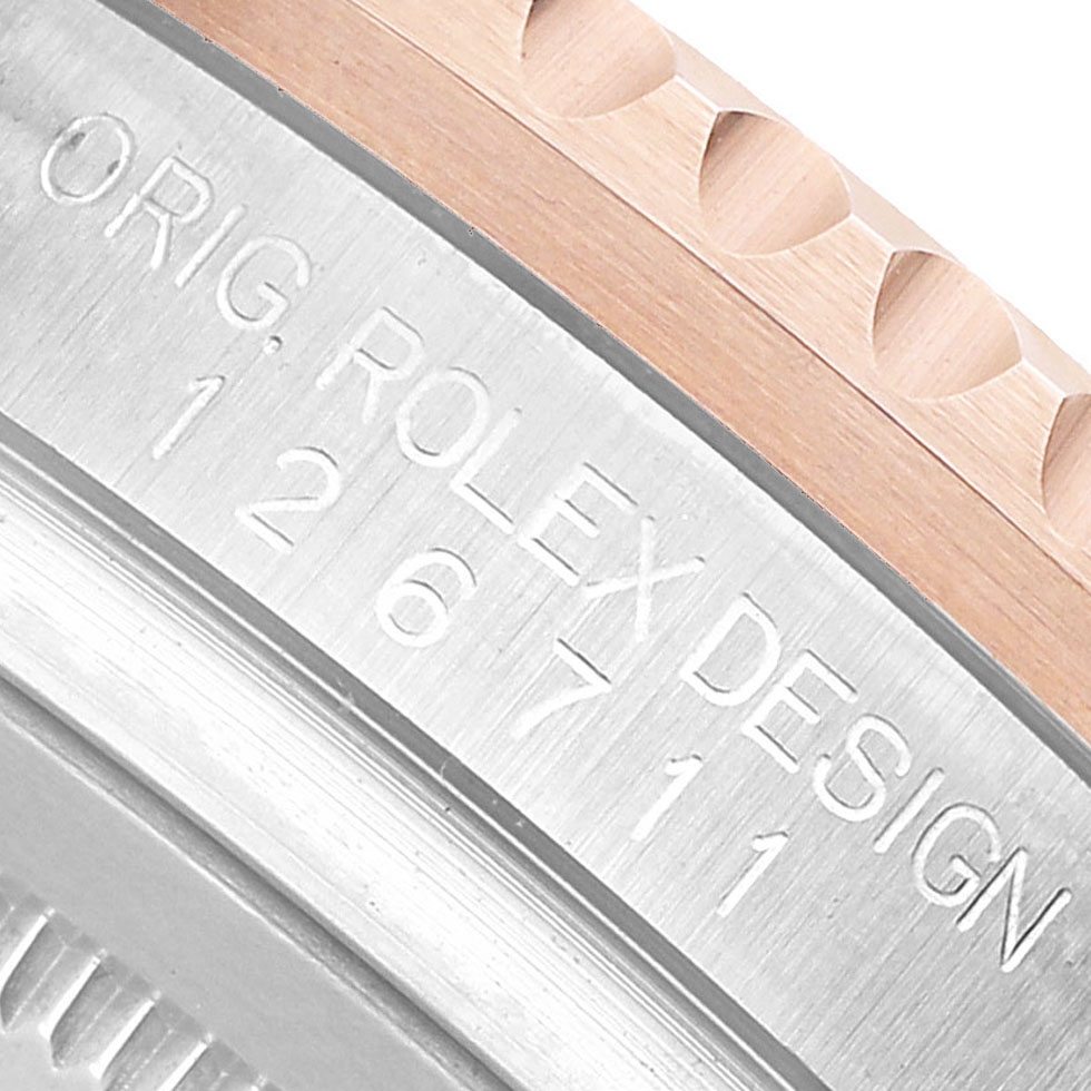 The image shows a close-up of the case side of a Rolex GMT-Master 126711 Men's Steel and Gold (two tone) Black Dial, highlighting the model number engravings and part of the bezel.