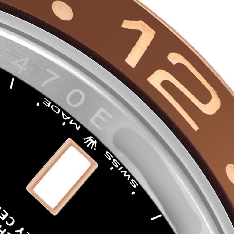 The image shows a close-up of the bezel and part of the dial of the Rolex GMT-Master 126711 Men's Steel and Gold (two tone) Black Dial, highlighting the numbers and markings.