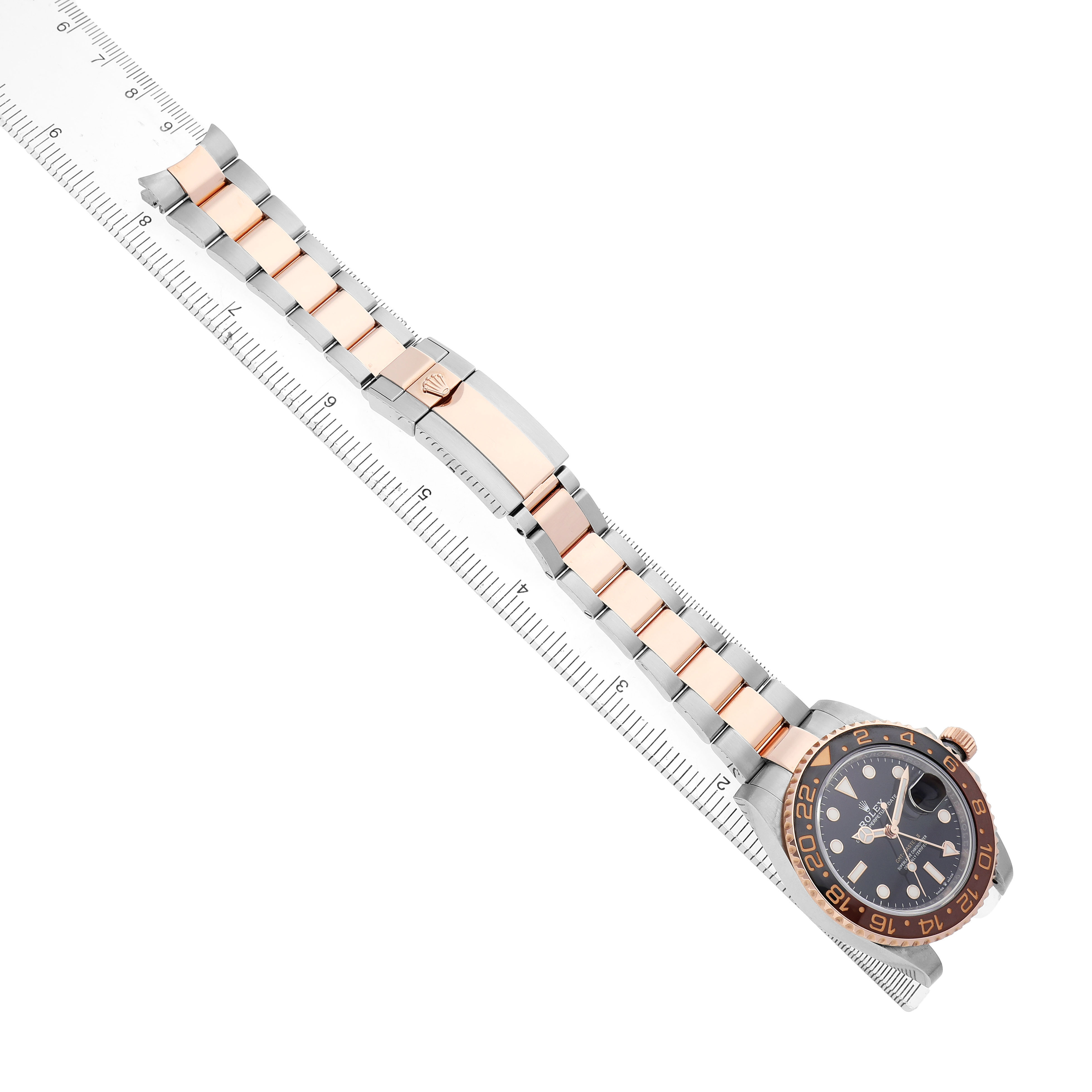 The Rolex GMT-Master 126711 Men's Steel and Gold (two tone) Black Dial watch is shown from an angled top view, highlighting the dial, bezel, and two-tone bracelet with a clasp.