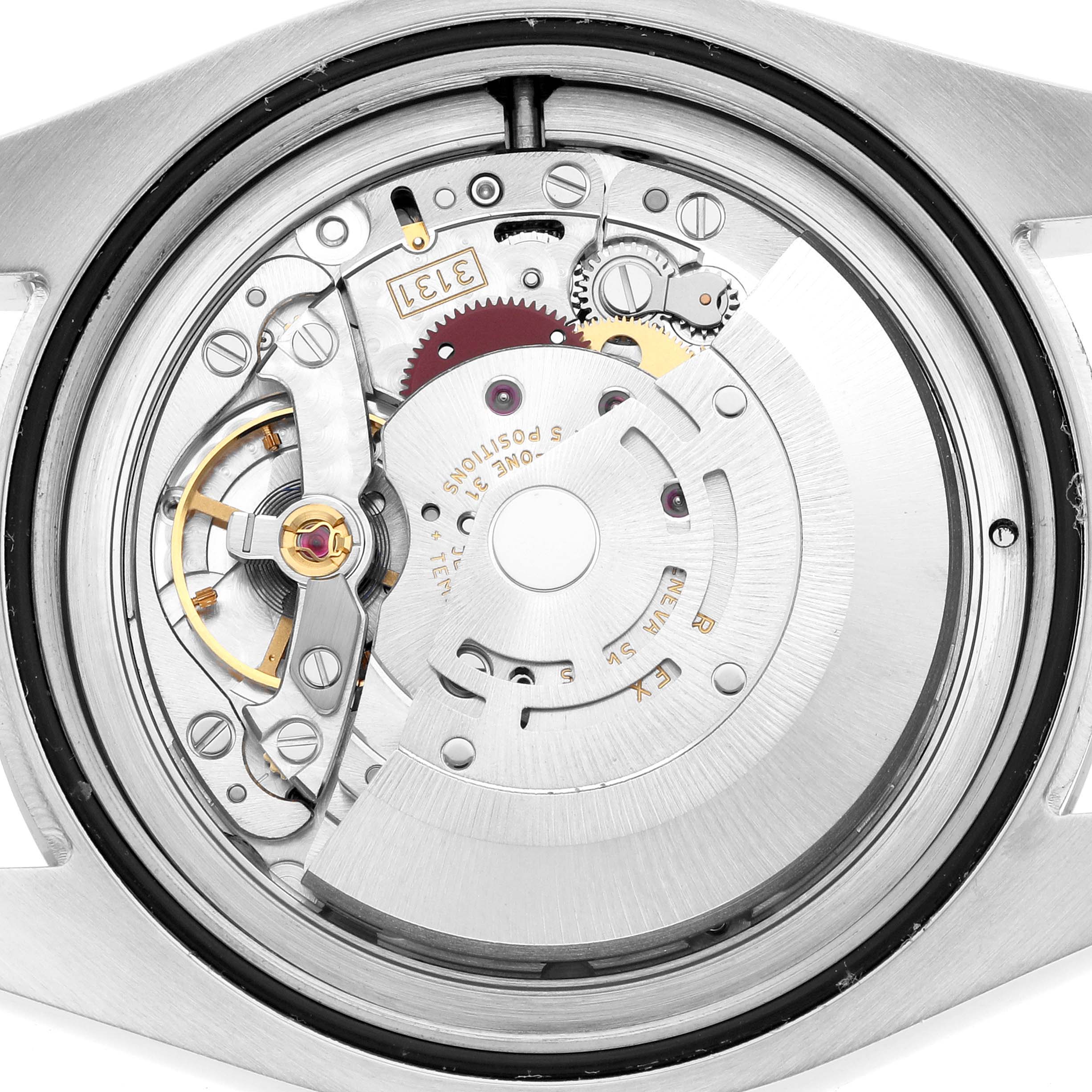 The image shows a close-up of the Rolex Milgauss 116400GV Men's Stainless Steel Black Dial watch movement from a rear angle, highlighting gears and intricate parts.