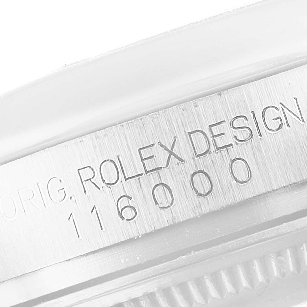 This image shows a close-up of the side of a Rolex Oyster Perpetual 116000 Men
s Stainless Steel Black Dial 116000 Men
s Stainless Steel Black Dial watch case, highlighting the engraving "ORIG. ROLEX DESIGN 116000."