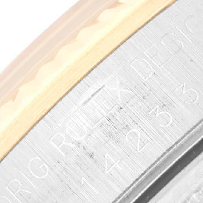 This close-up angle shows the engraved text on the casing of the Rolex Oyster Perpetual 14233 Men's Stainless Steel Champagne Dial 14233 Men's Stainless Steel Champagne Dial watch.