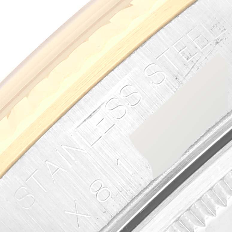 This close-up image shows part of the caseback engraving of a Rolex Oyster Perpetual 14233 Men's Stainless Steel Champagne Dial 14233 Men's Stainless Steel Champagne Dial watch, with "STAINLESS" visible.