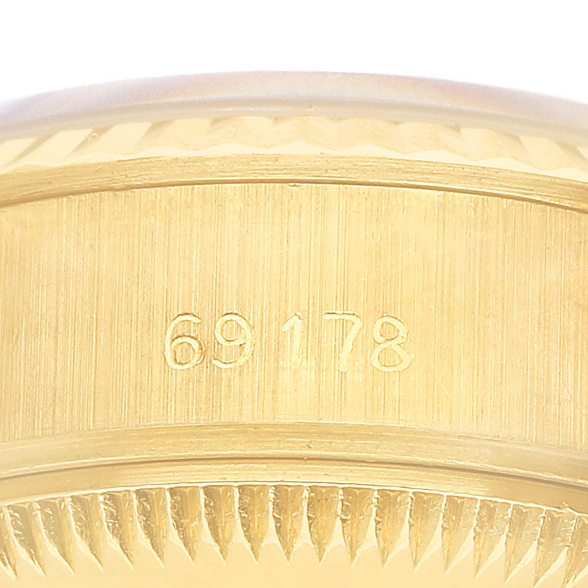The image shows the side of a Rolex President 69178 Women's Yellow Gold Champagne Dial model watch with the case number engraved.