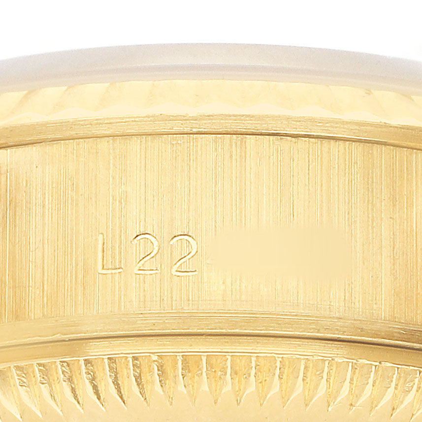 The image shows a close-up of the case edge and serial number on the Rolex President 69178 Women's Yellow Gold Champagne Dial watch.