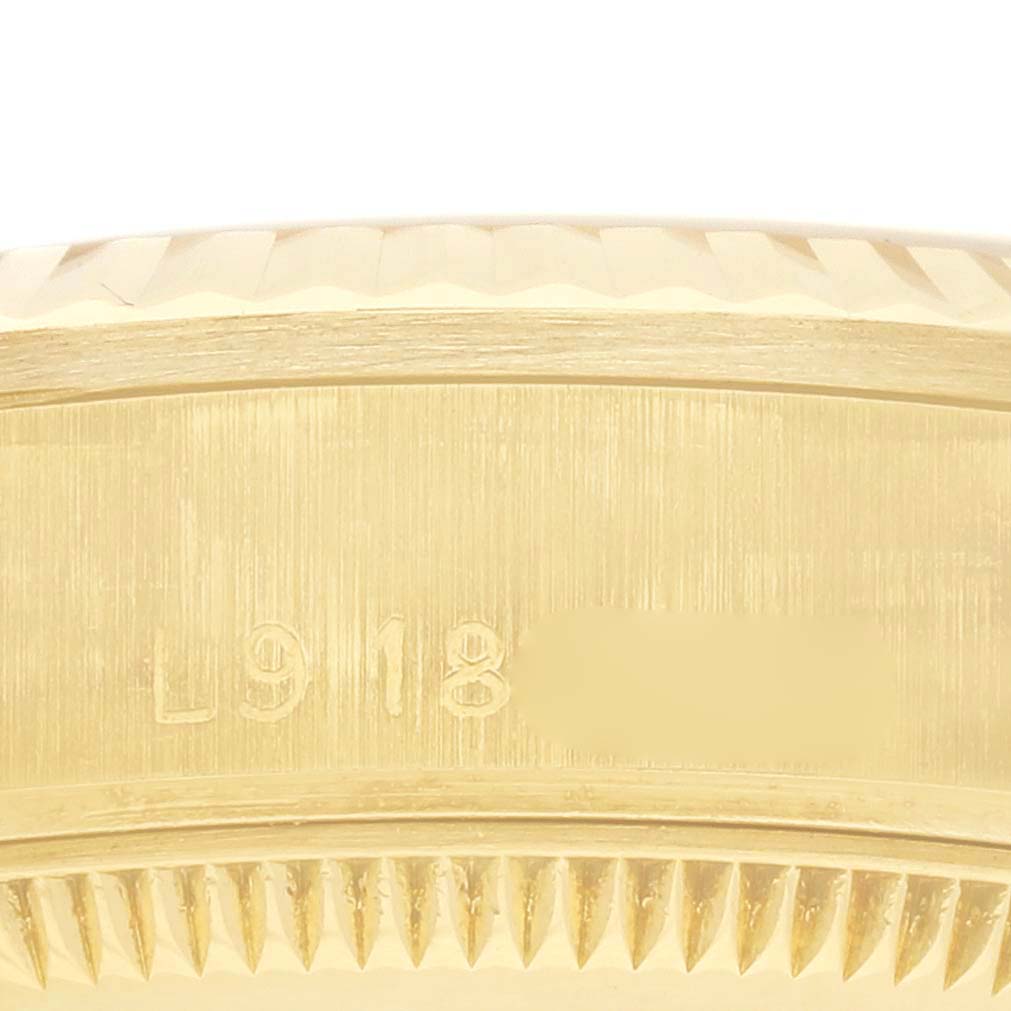 This image shows the side of the bezel and edge engraving of a Rolex President 68278 Women's Yellow Gold White Dial 68278 Women's Yellow Gold White Dial watch.