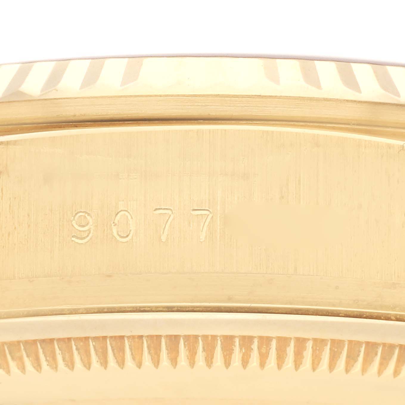 The image shows a close-up of the side view of the case and bezel of a Rolex President 18038 Men
s Yellow Gold Champagne Dial 18038 Men
s Yellow Gold Champagne Dial model, featuring fluted edges and a serial number.