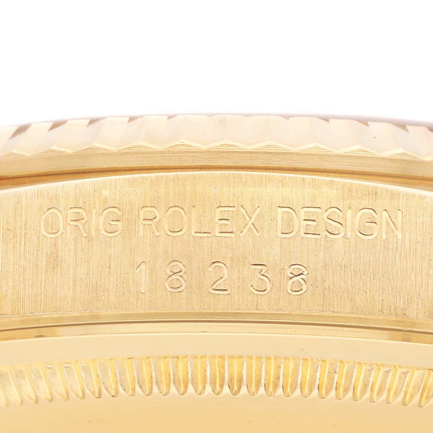 The image shows the side of a Rolex President 18238 Men
s Yellow Gold Champagne Dial 18238 Men
s Yellow Gold Champagne Dial watch, focusing on the engraved model number 18238.