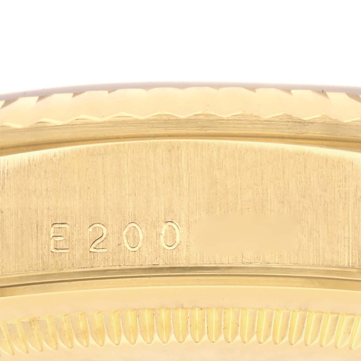 The image shows a close-up of the case side of a Rolex President 18238 Men
s Yellow Gold Champagne Dial 18238 Men
s Yellow Gold Champagne Dial model, highlighting the engraved markings.