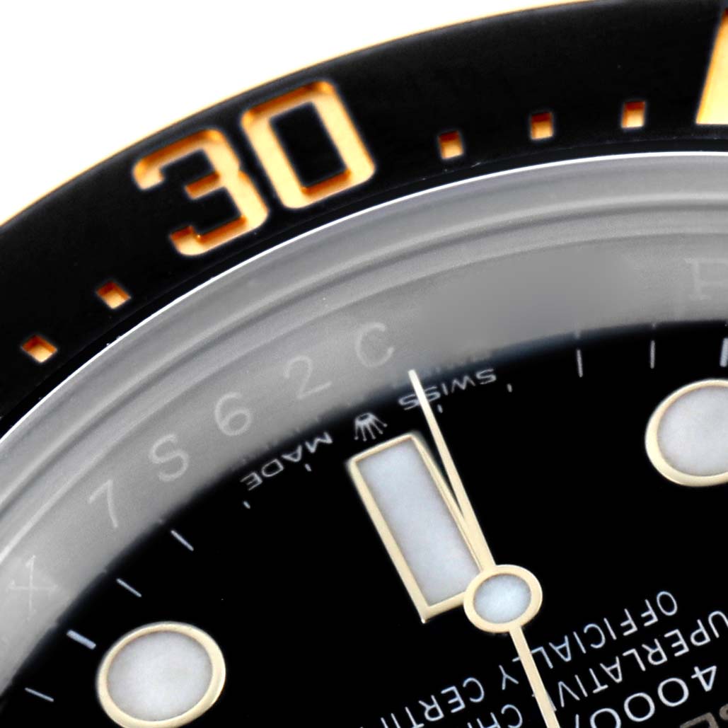 The image shows a close-up angle of the Rolex Sea-Dweller 126603 Men's Steel and Gold (two tone) Black Dial's bezel, dial, and part of the minute hand.