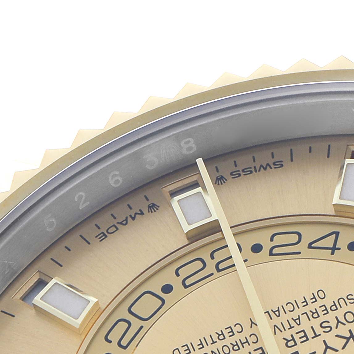 The image shows a close-up of the Rolex Sky-Dweller 336933 Men's Steel and Gold (two tone) Champagne Dial's dial and fluted bezel, highlighting markers and part of the watch face.