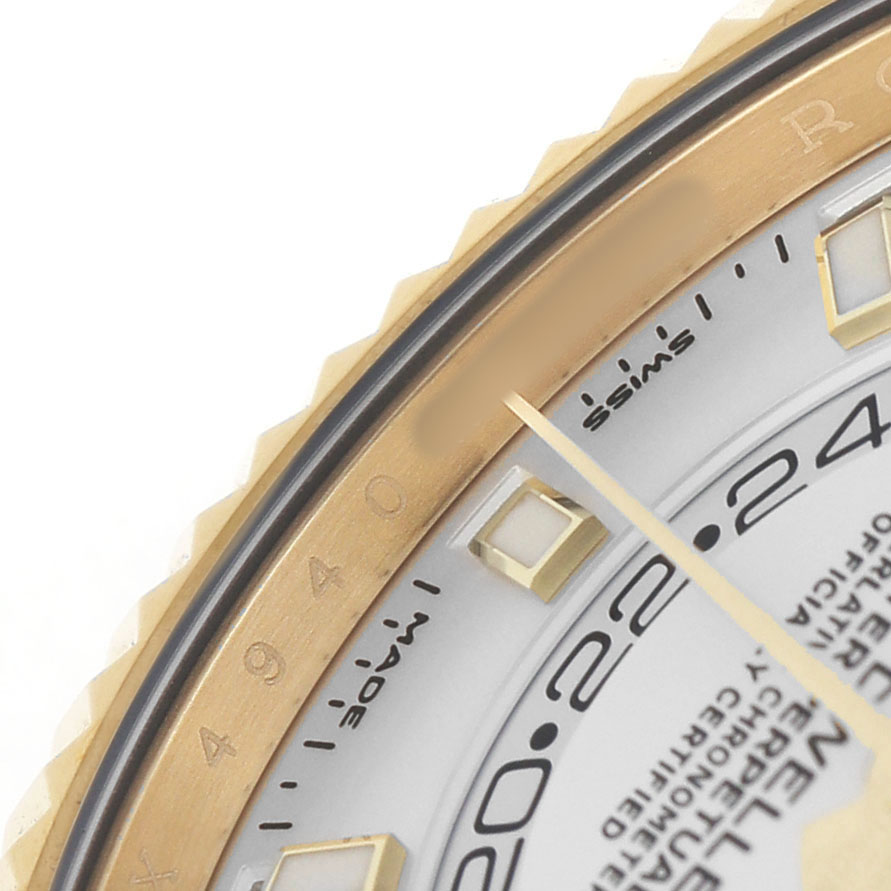 The image shows a close-up of the Rolex Sky-Dweller 326238 Men's Yellow Gold White Dial watch, highlighting the gold bezel and parts of the dial and markers.