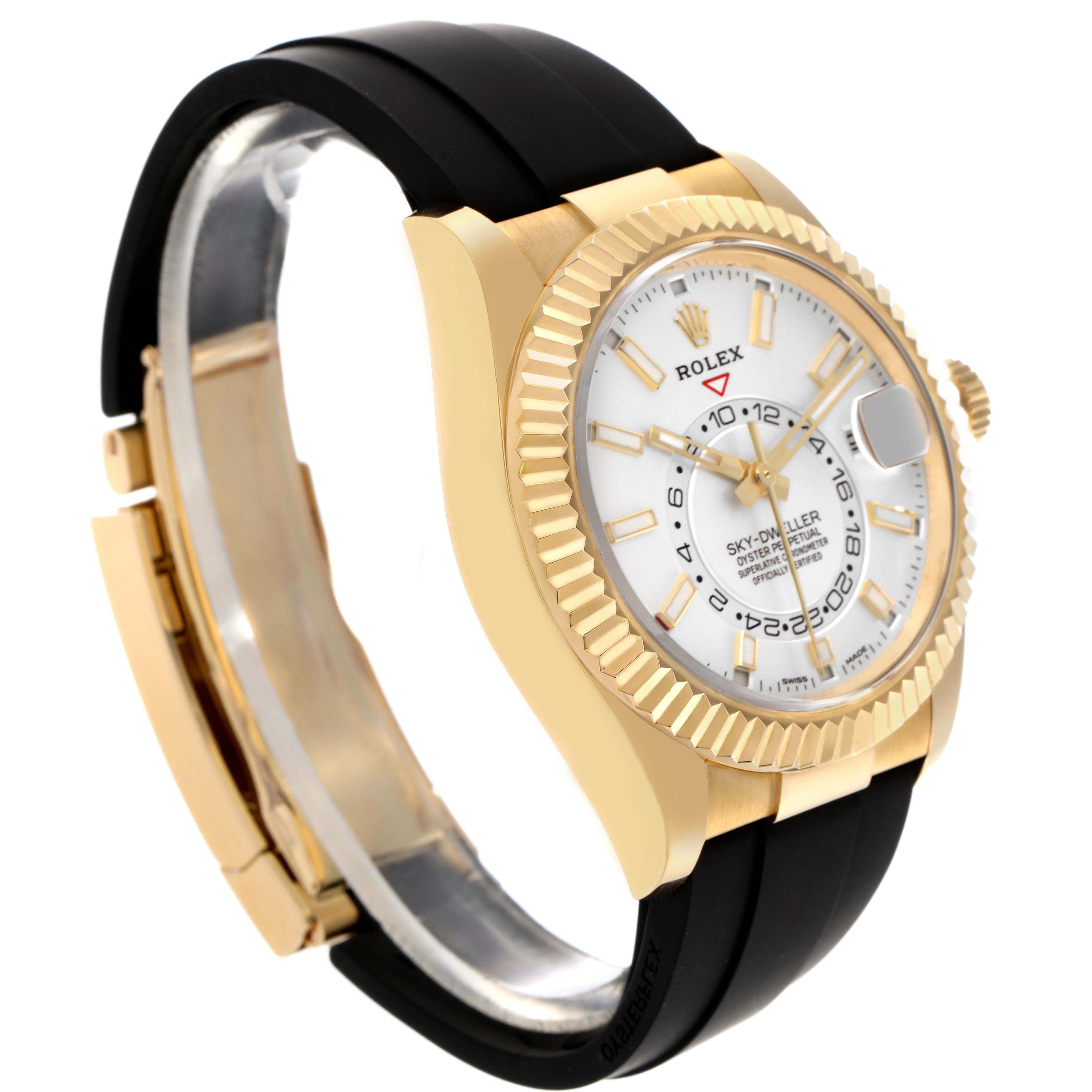 The Rolex Sky-Dweller 326238 Men's Yellow Gold White Dial watch is shown at an angle highlighting the gold case, fluted bezel, black strap, and detailed dial.