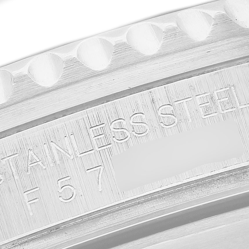 The image shows a close-up of the side engraving and edge of the bezel of a Rolex Submariner 16610 Men's Stainless Steel Black Dial watch, highlighting the "STAINLESS STEEL" text.