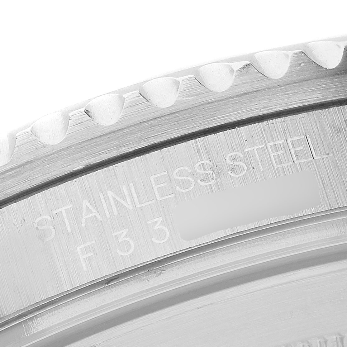 The image shows a close-up angle of the stainless steel back casing of a Rolex Submariner 16610 Men's Stainless Steel Black Dial watch.