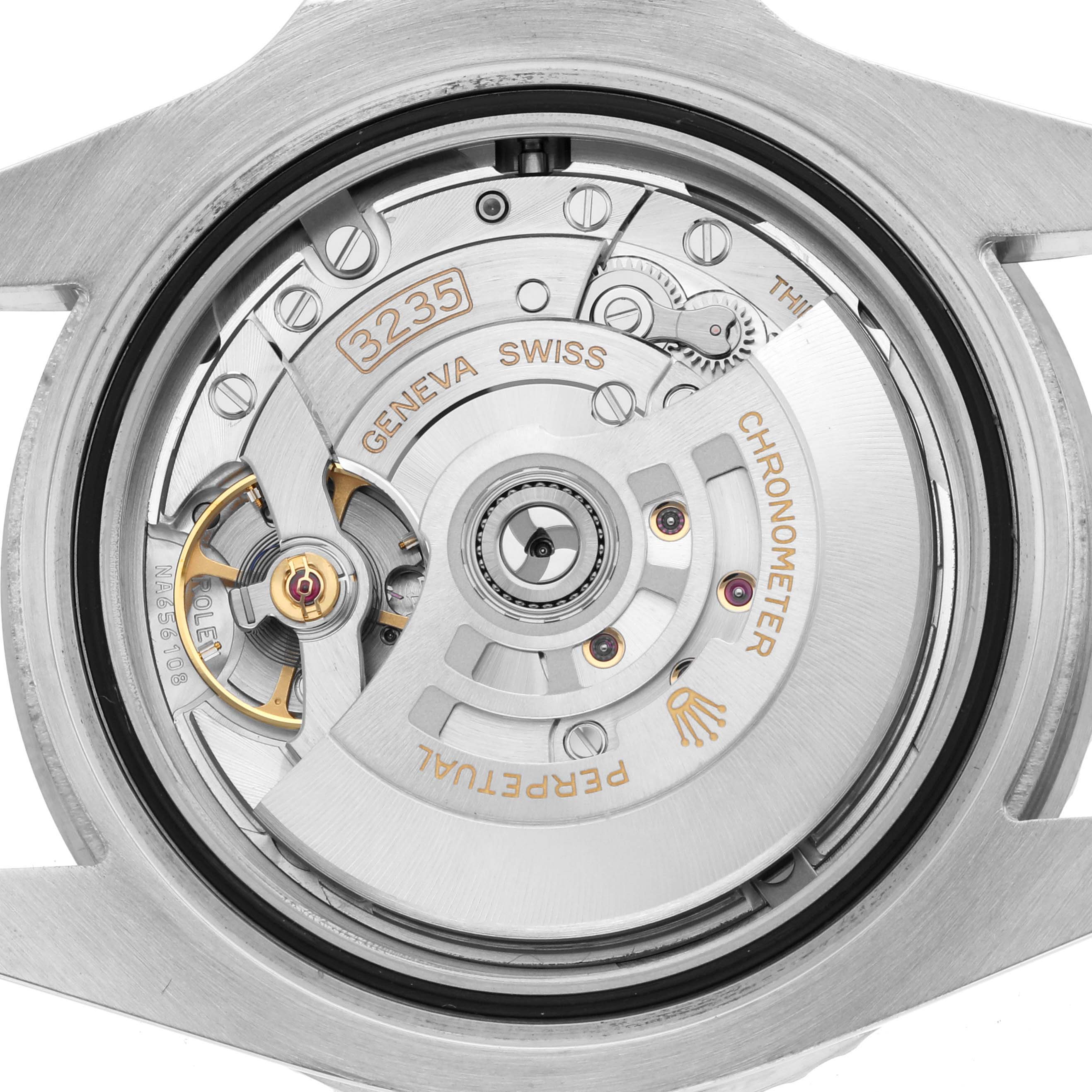 The image shows the movement of a Rolex Submariner 126610LV Men's Stainless Steel Black Dial watch from a top-down angle, highlighting the rotor and intricate mechanics.