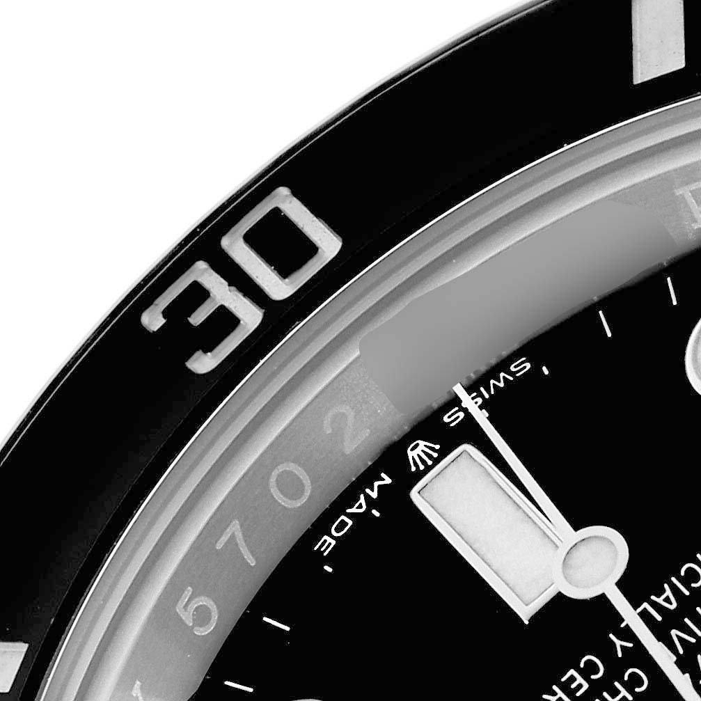 The image shows a close-up of the Rolex Submariner 126610 Men's Stainless Steel Black Dial's dial and bezel at an angle, highlighting the minute markers and part of the hands.