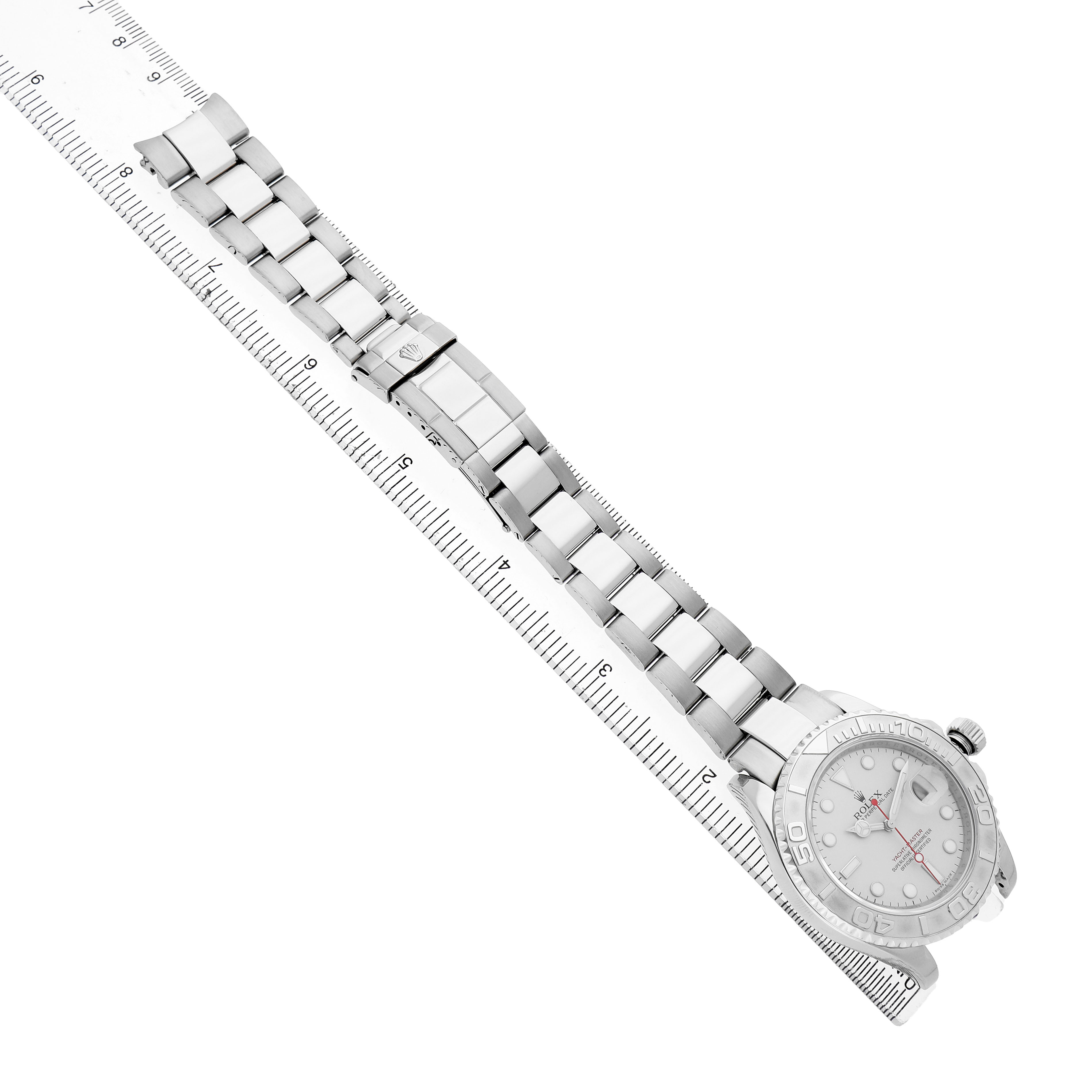 The Rolex Yacht-Master 16622 Men's Stainless Steel Silver Dial watch is shown from a top angle with its bracelet and clasp visible alongside a ruler.