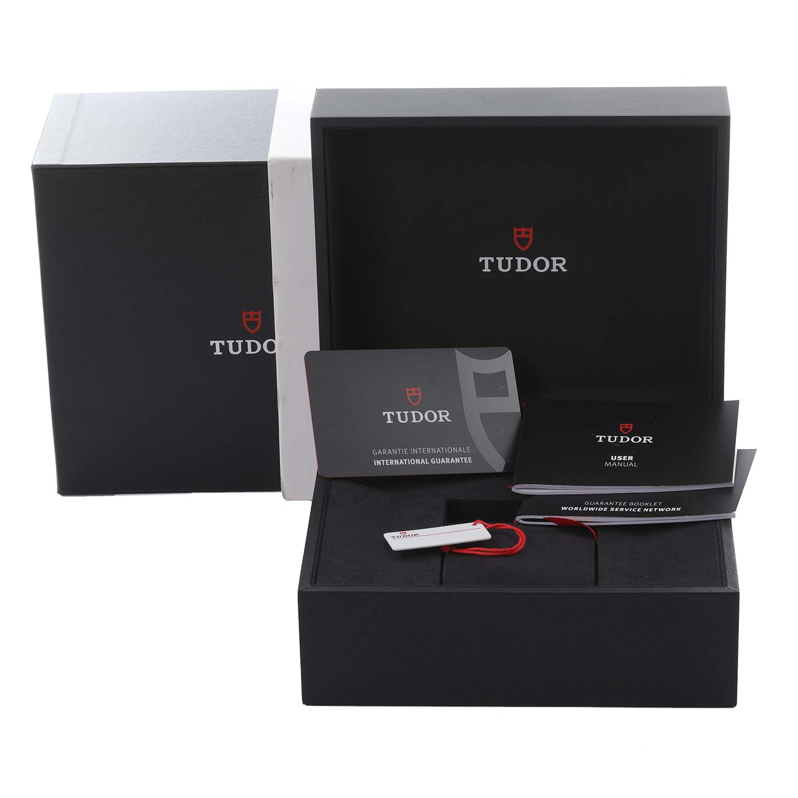 The Tudor Heritage Black Bay packaging includes boxes, warranty card, user manual, and a tag shown from a frontal angle.