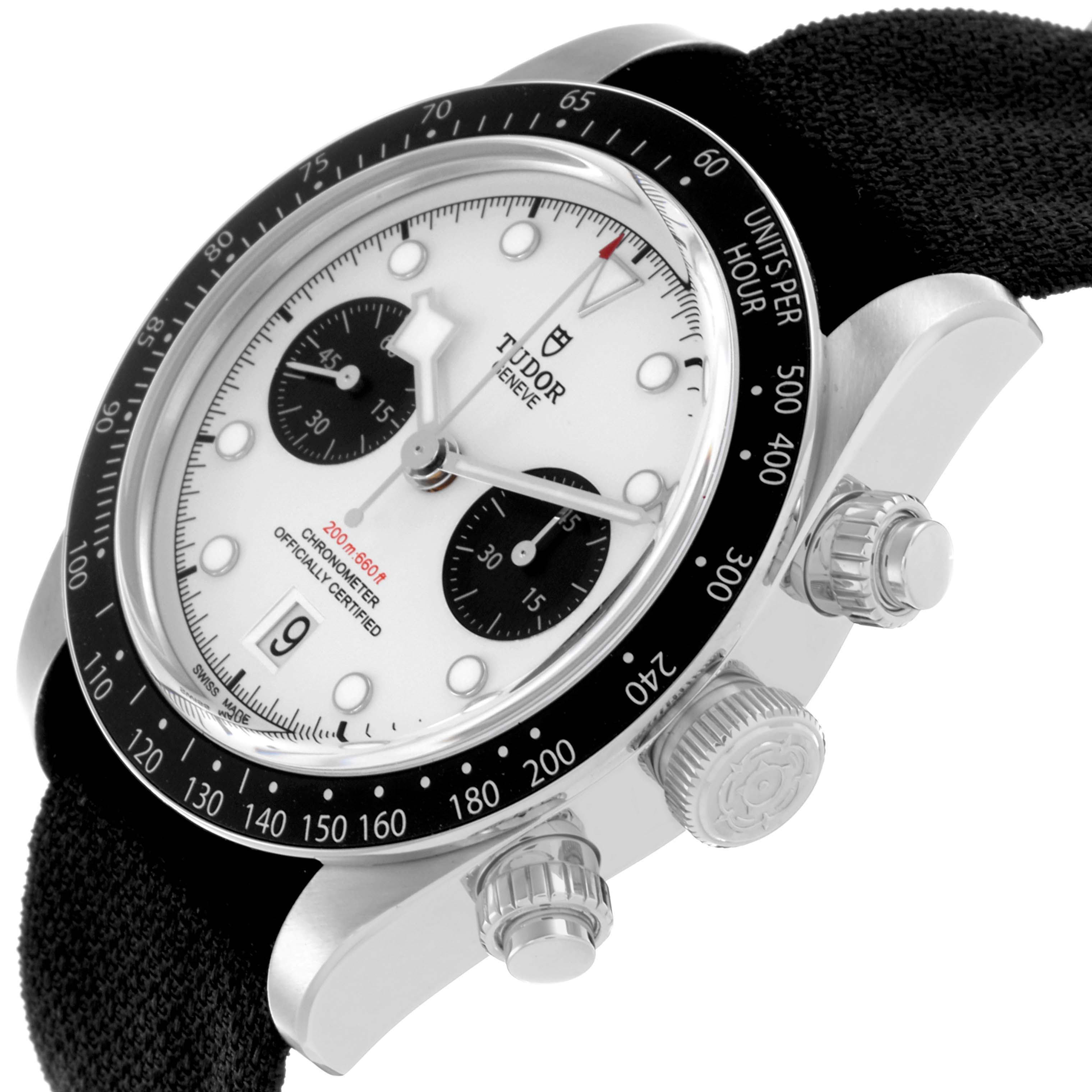 The Tudor Heritage Black Bay watch is shown from a side angle, highlighting the dial, bezel, crown, and pushers.